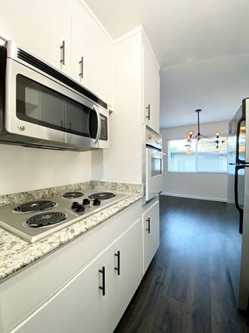 Kitchen with stove top and microwave 